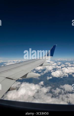 Clear blue skies with puffs of white clouds as seen from a Delta Airlines domestic flight, 2025, United States Stock Photo