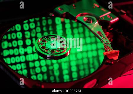 moving hard drive head with green data on drive Stock Photo