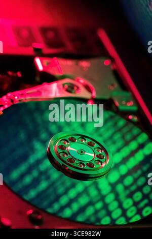 moving hard drive head with green data on drive Stock Photo