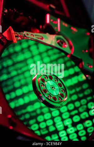 The computer code is displayed in green numbers on the open hard disk Stock Photo