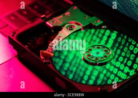 The computer code is displayed in green numbers on the open hard disk Stock Photo