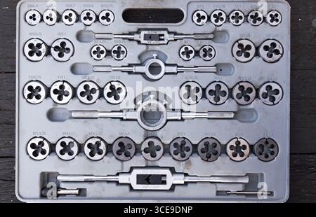 A set of hand tools with dies and taps for cutting threads. Stock Photo