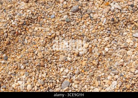 Close-up of small colorful beach pebbles and stones forming a natural texture Stock Photo