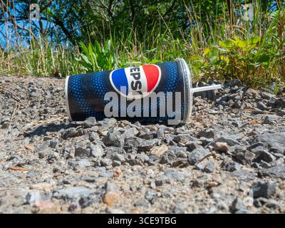 Discarded empty paper beverage cup. Stock Photo