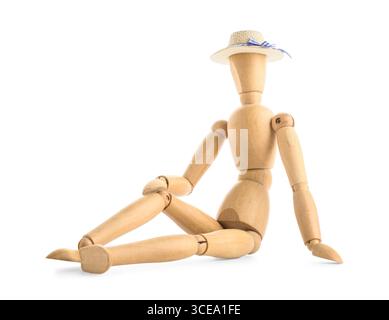 Wooden mannequin in straw hat sitting on white background Stock Photo