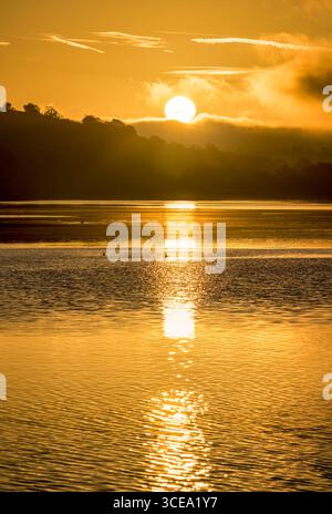 The first rays of the sun over lake Ladoga in the morning in winter ...