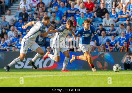 16 August 2025. Glasgow, UK. Rangers played Alloa Athletic at Ibrox Stadium, Glasgow, in the Premier Sports Cup. The final score was Rangers 4 - 2 Alloa Athletic. Mikey Moore (R47) runs towards the ball pursued by Owen Foster (A24) and Scott Taggert (A2) Credit: Findlay / Alamy Live News Stock Photo
