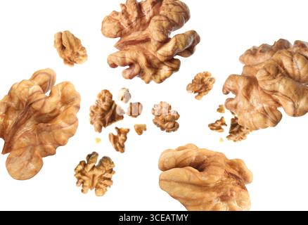 Walnuts swirling in air against white background Stock Photo