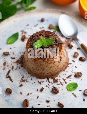Homemade chocolate and coffee flan decorated with fresh mint. Traditional egg recipe. Stock Photo
