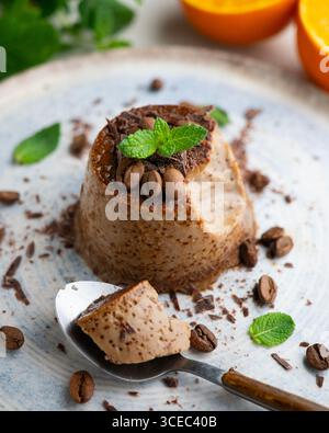 Homemade chocolate and coffee flan decorated with fresh mint. Traditional egg recipe. Stock Photo