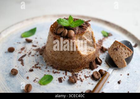 Homemade chocolate and coffee flan decorated with fresh mint. Traditional egg recipe. Stock Photo