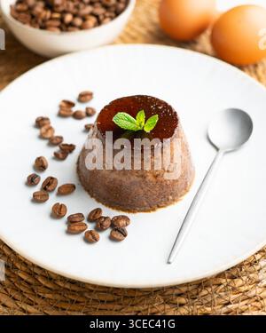 Homemade coffee flan decorated with fresh mint. Traditional egg recipe. Stock Photo
