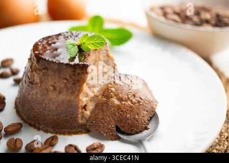 Homemade coffee flan decorated with fresh mint. Traditional egg recipe. Stock Photo