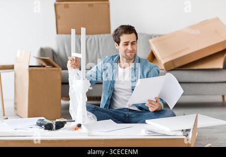 Difficulties and problems in assembling new furniture at home without master Stock Photo