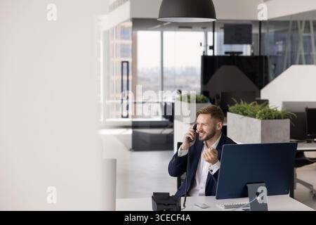 Happy successful business company employee man working in contemporary office Stock Photo