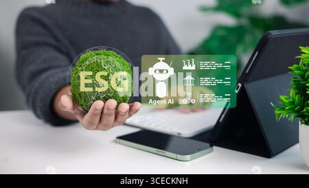 Hand holding ESG symbol with AI agent icons on tablet, representing sustainability, corporate governance, environmental responsibility, and digital te Stock Photo