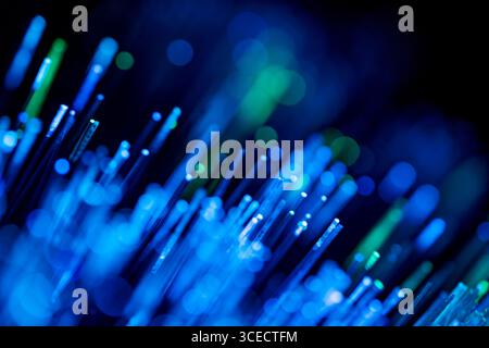 A mesmerizing abstract image of blue and green fiber optic lights, creating a vibrant and dynamic visual effect resembling a magical light show in the Stock Photo
