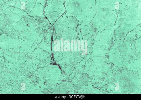 Close-up image of a turquoise stone surface with visible cracks and rough texture. The natural pattern provides a detailed and captivating abstract ba Stock Photo