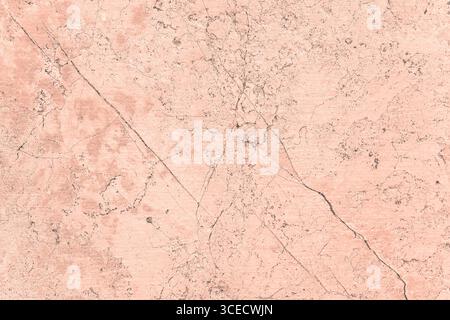 A close-up image of a pink concrete surface with cracks and natural patterns. The textured background highlights the rough and detailed surface featur Stock Photo