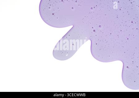 Close-up of a purple cosmetic gel with tiny bubbles and a smooth texture spread on a white background, illustrating beauty product textures and colors Stock Photo