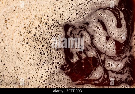 A detailed macro shot showcasing the rich texture of foamy coffee, highlighting its bubbly structure and creamy surface. Ideal for beverage, texture, Stock Photo