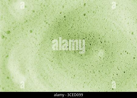 A detailed macro image showcasing the vibrant texture of matcha foam. The soft green bubbles create a soothing pattern, offering a refreshing and orga Stock Photo