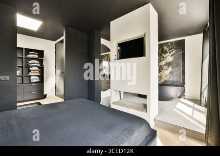 A sleek, modern bedroom featuring a neutral color palette, minimalist furniture, and innovative layout with natural light accents. Stock Photo