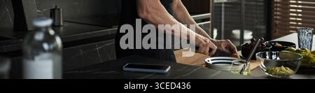 Middle Aged Caucasian Man Preparing Food in Modern Kitchen While Cooking Stock Photo