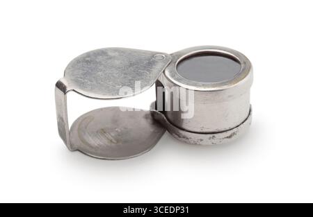 Old magnifying glass in a metal case isolated on white. Stock Photo