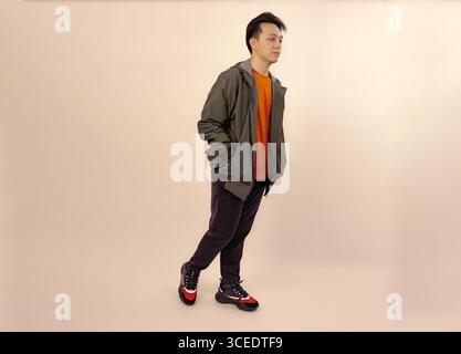 young adult male in casual clothing posing against neutral background Stock Photo