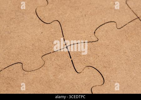 Close up jigsaw puzzle piece on brown paper background Stock Photo