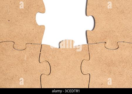 Closeup with the missing piece of the puzzle pieces connected to each other on a white background Stock Photo