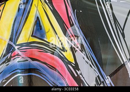 Abstract image displaying a colorful and dynamic mix of lines, shapes, and patterns in shades of blue, yellow, red, and black Stock Photo