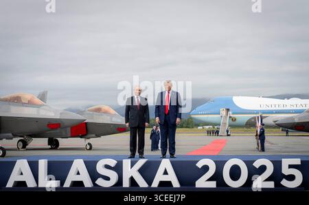 Anchorage, United States of America. 15 August, 2025. U.S. President Donald Trump, right, stands with Russian President Vladimir Putin, left, during the arrival ceremony at Joint Base Elmendorf Richardson, August 15, in Anchorage, Alaska. Trump is hosting Putin for talks to end the Russian war in Ukraine.  Credit: Benjamin Applebaum/DOD Photo/Alamy Live News Stock Photo
