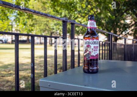An abandoned, empty bottle of Hobgoblin Ruby Beer - A devishly fruity gem - Charlotte Square, Edinburgh, Scotland, UK. Stock Photo