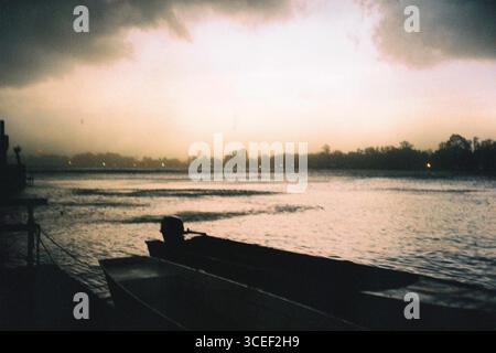 Before Storm. An analog photograph of the river on the Sava before a big storm, with high contrast and pastel tones. In the foreground, there are two Stock Photo