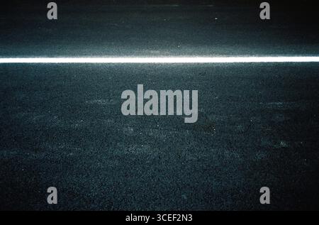 Freshly painted vertical signage on a newly paved local concrete road, photographed analog-style with Kodak Gold and an Olympus Mju, in a high-contras Stock Photo