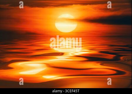 Vibrant sunrise or sunset casts warm colours on calm water, creating brilliant golden reflections Stock Photo