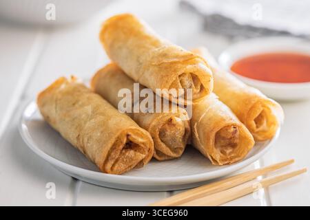 Fried spring rolls on plate on a white table. Stock Photo
