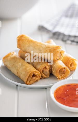Fried spring rolls on plate on a white table. Stock Photo