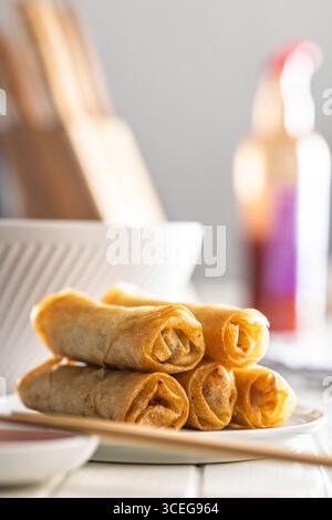 Fried spring rolls on plate on a white table. Stock Photo