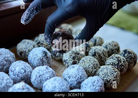 Delicious vegan date and nut cocoa sweets placed in a casual kitchen setting Stock Photo