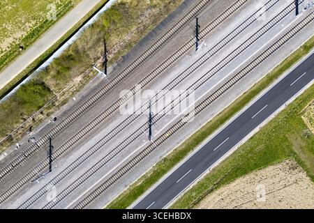 Aerial view of parallel lines of transportation infrastructure contrasting with the natural landscape, including railways and roads, Deutschlandsberg, Steiermark, Austria. Stock Photo