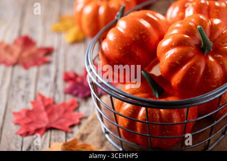 autumn pumpkins background on rustic wooden background with autumn leaves Stock Photo