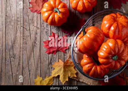 autumn pumpkins background on rustic wooden background with autumn leaves Stock Photo