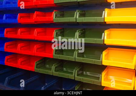 A wall with plastic containers for storing small parts. Stock Photo