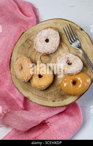 round, ring-shaped donut. The donut has a golden-brown,  textured exterior with a soft and fluffy interior, visible from the hole in the center Stock Photo
