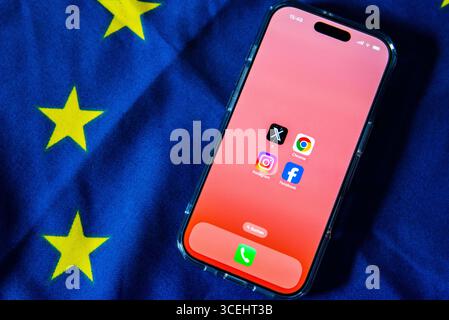 29 July 2025, Belgium, Brüssel: The logos of Facebook, Instagram, X (formerly Twitter) and Google Chrome can be seen on the screen of a smartphone resting on an EU flag. The European Union is making large online platforms and browser providers more accountable with laws such as the Digital Services Act (DSA) and the Digital Markets Act (DMA). Photo: Alicia Windzio/dpa Stock Photo