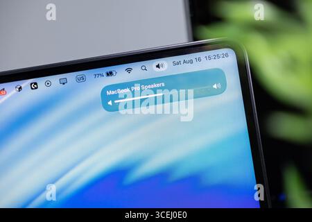 Poznan, Poland - August 15, 2025: Liquid Glass macOS 26 interface displays MacBook Pro Speakers volume, showcasing advanced digital audio systems Stock Photo
