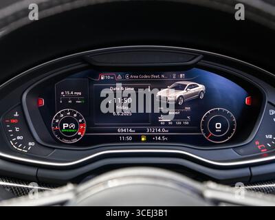 Derby, UK - August 18 2025: digital instrument cluster in a modern car, featuring a high-resolution display with speed, navigation, and driving data p Stock Photo